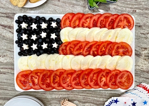 Flag style arrangement of Bennett Blueberries, mozzarella and tomato for the perfect spread. 